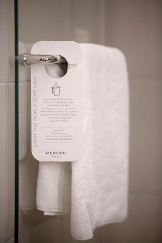 a roll of toilet paper on a dispenser in a bathroom at Mercure Belgrade Excelsior in Belgrade