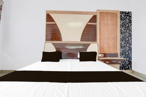 a bedroom with a white bed and a window at Hotel O Lord Krishna in Alīgarh