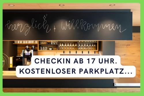 a sign in front of a restaurant with a bar at Landgasthof Linde - In ruhiger, ländlicher Umgebung in Deggenhausertal