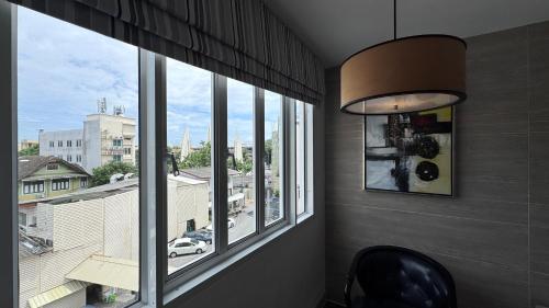 a room with a window with a view of a city at Methavalai Residence Hotel in Bangkok