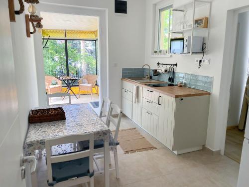 a kitchen with a table and a counter top at Arany Toboz Vendégház in Siófok