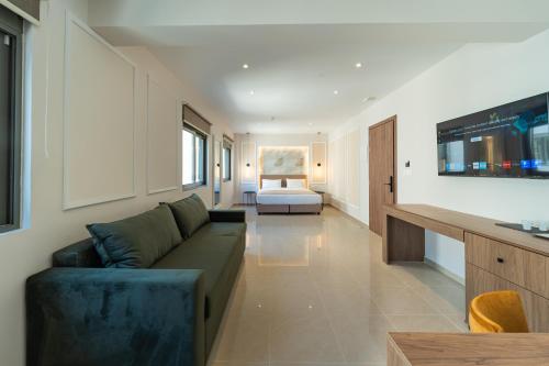 a living room with a couch and a bed at Philia Center Suites in Rhodes Town