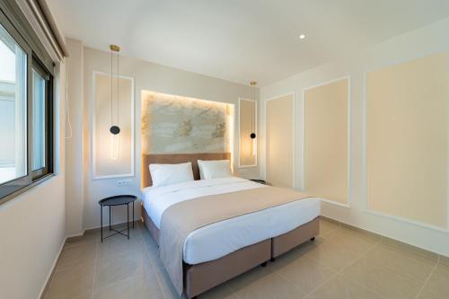 a bedroom with a large bed and a window at Philia Center Suites in Rhodes Town