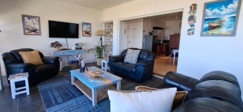 a living room with a couch and chairs and a table at Tweede Wind in Yzerfontein