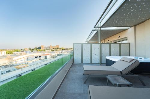 a balcony with a couch and a table on a building at Philia Center Suites in Rhodes Town