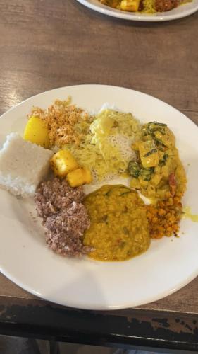 a white plate of food on a table at Anandas Beach Resort in Trincomalee