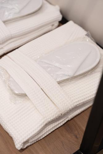 a stack of white napkins sitting on top of a table at Philia Center Suites in Rhodes Town