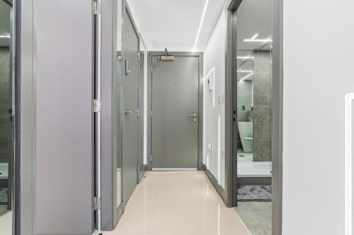 a bathroom with a walk in shower and a glass door at Luxury City Apartment, Walk to O2 Academy & Bullring, Sleeps 4 in Birmingham