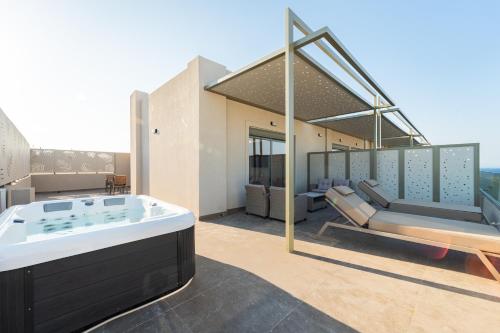 a hot tub on the roof of a house at Philia Center Suites in Rhodes Town