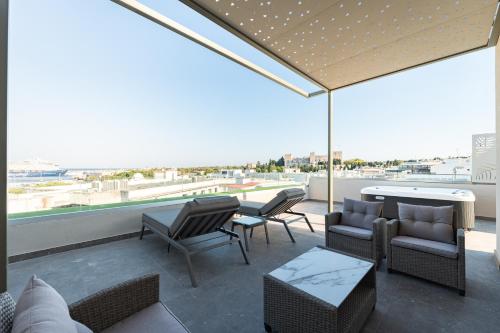 a patio with chairs and a table and a view at Philia Center Suites in Rhodes Town