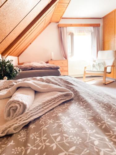 a bedroom with two beds and a staircase at Chalupa Rozálka in Cerny Dul