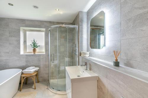 a bathroom with a shower sink and a bath tub at Spring Bank View - Holmfirth in Holmfirth