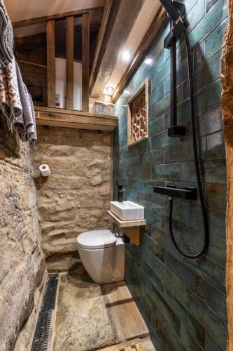 a bathroom with a toilet and a shower at Woolcombers in Addingham