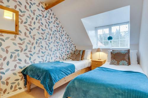 En eller flere senge i et værelse på Smugglers Cove Cottage