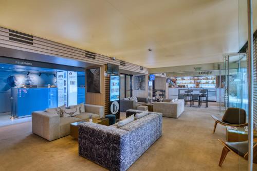 a living room with couches and a dining room at Lucky Bansko Aparthotel SPA & Relax in Bansko