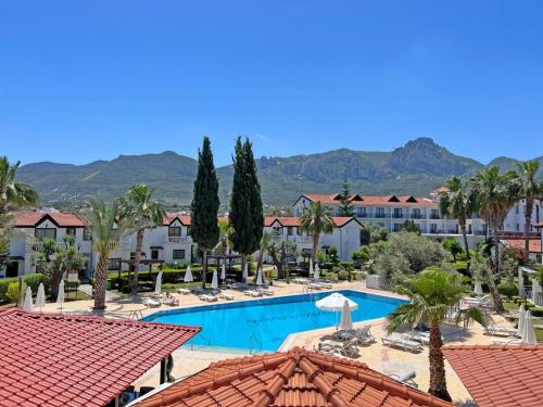 a view of the pool at a resort with palm trees at Monaco Flats in Kérynia