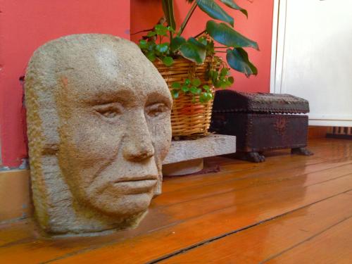 a statue of a head sitting on a floor at Hotel Churup in Huaraz
