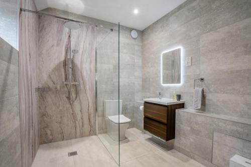 a bathroom with a shower and a toilet and a sink at Bells Barn in Crakehall
