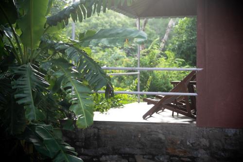 a view of a porch with a table and umbrella at The Sky Imperial Jungle Camp Resort in Kumbhalgarh