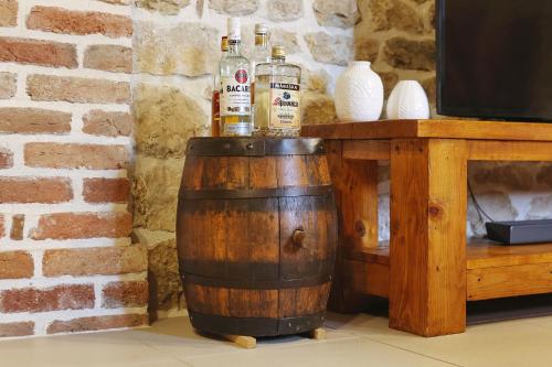 two bottles of alcohol sitting on top of a barrel at Villa Romantika Dalmacija in Nin