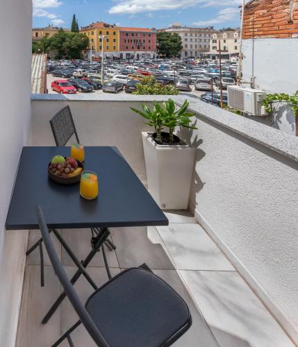 a table and chairs on a balcony with a view of a city at NEW! Oldie but goldie in Split