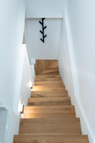 a staircase in a house with white walls and wood floors at NEW! Oldie but goldie in Split