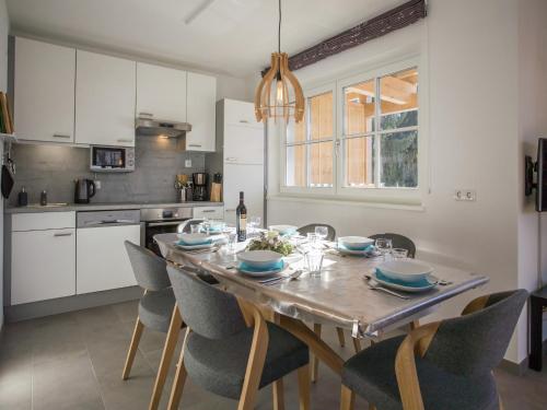 a kitchen with a dining room table and chairs at Modern Apartment near Ski Area in Brixen im Thale in Feuring