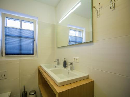 a white bathroom with a sink and a mirror at Modern Apartment near Ski Area in Brixen im Thale in Feuring