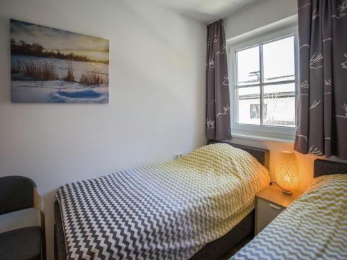 a bedroom with two twin beds and a window at Modern Apartment near Ski Area in Brixen im Thale in Feuring