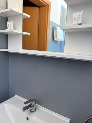 a bathroom with a sink and a mirror at Villa Sulejówek in Sulejówek