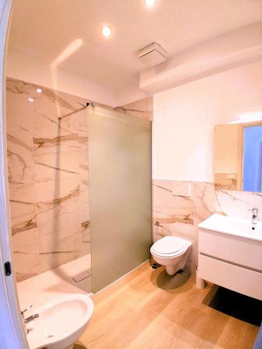 a bathroom with a shower and a toilet and a sink at Virgy White rooms in Bari