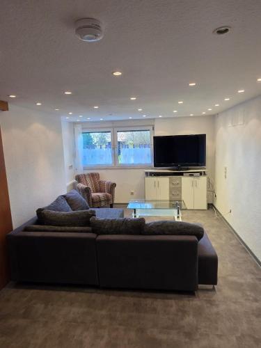a living room with a couch and a table at Relax - Beautiful 2 rooms in Satteldorf