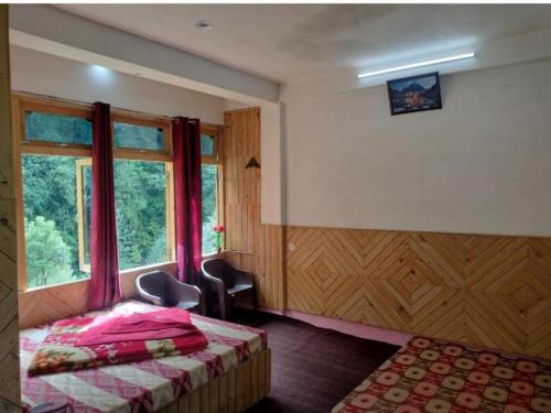 a bedroom with a bed and a window at aman place homestay river touch in Jibhi