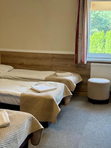 a room with two beds and a window at Villa Sulejówek in Sulejówek