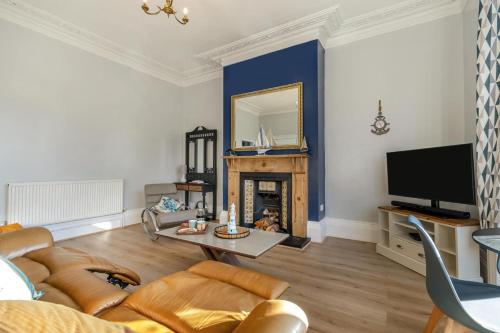 a living room with a couch and a fireplace at The Blue Door Apartment in Bridlington