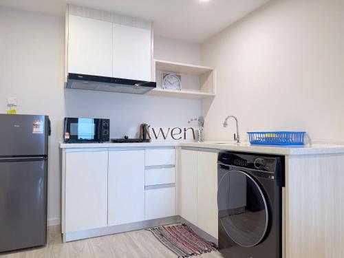 a kitchen with a washer and a dishwasher at KWEN Suites-Tanjung Aru InfinityPool Seaview/Airport View in Kota Kinabalu