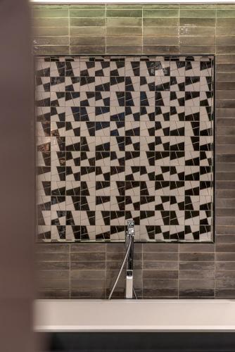 a black and white tile wall in a bathroom at Kaan Casablanca in Casablanca