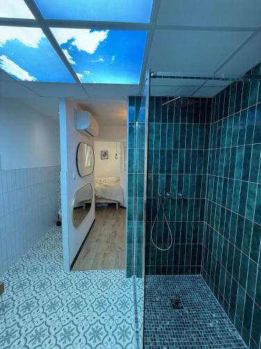 a bathroom with a shower and a toilet and a bedroom at F2 Neuf Luxe Centre Haguenau Parking Gratuit in Haguenau