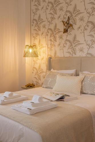 a bedroom with a bed with towels on it at Porta do Jardim in São Pedro do Sul