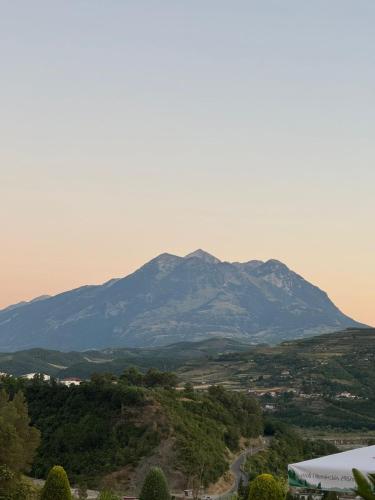 a mountain in the distance with a road in the foreground at Erta Hotel and Restaurant in Gramsh