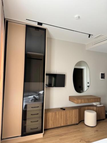 a room with a mirror and a dresser at Erta Hotel and Restaurant in Gramsh