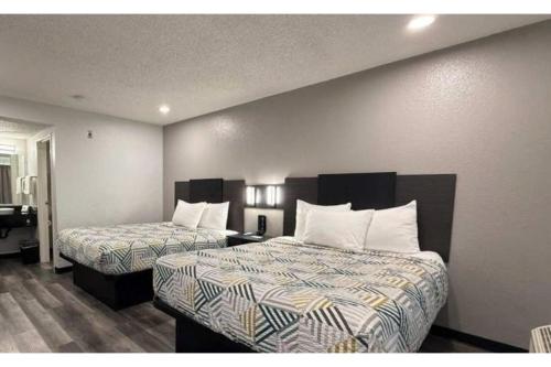 a hotel room with two beds with white pillows at Motel 6-Ely, NV in Ely