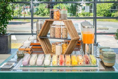a display of different types of food on a counter at Hotel Münster Kongresscenter affiliated by Meliá in Münster