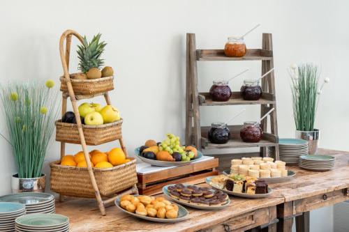 a table topped with baskets of fruit and desserts at Hotel Münster Kongresscenter affiliated by Meliá in Münster