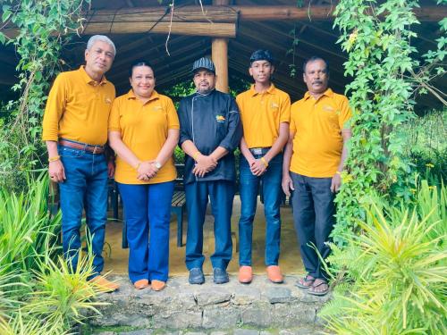 a group of men in yellow shirts posing for a picture at Hanthana Eco Lodge in Kandy