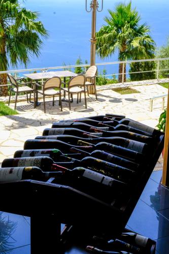 a bunch of wine bottles sitting on top of a table at Hotel Palasa in Palasë