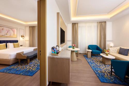a hotel room with a bed and a couch at Sarovar Premiere Amritsar in Amritsar