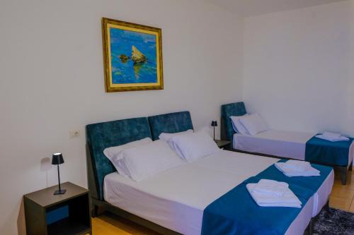a hotel room with two beds and a table at Hotel Palasa in Palasë