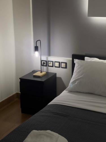a bedroom with a bed and a lamp on a night stand at Casa Maria-Anneta in Kalyves Poligirou