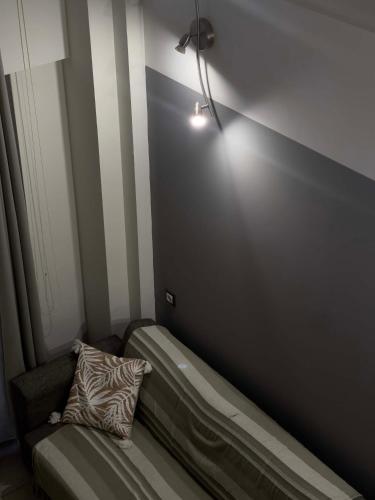 a room with a bed with a light on the wall at Casa Maria-Anneta in Kalyves Poligirou